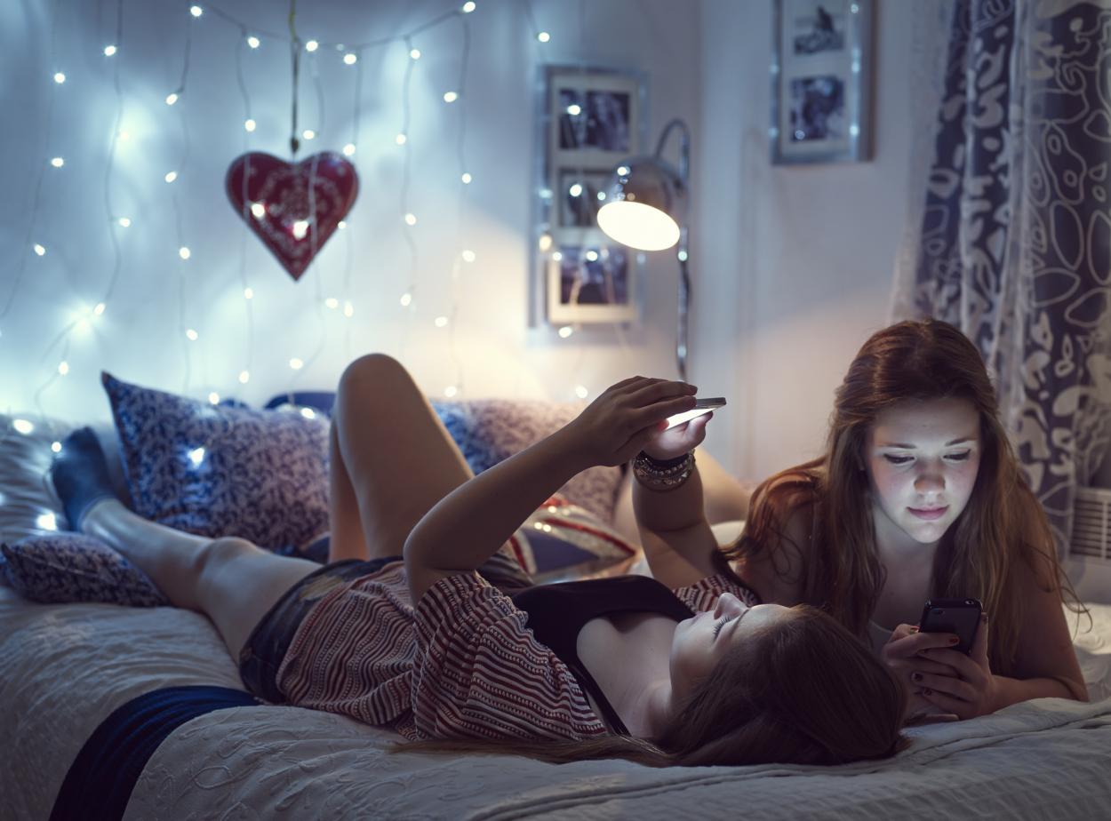 Two girls reading their phones
